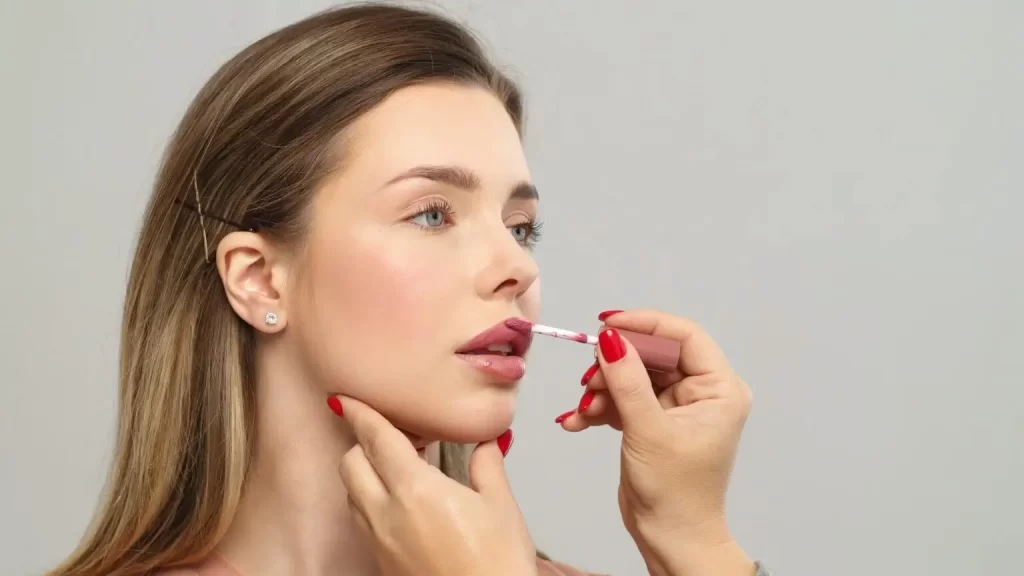 makeup-artist-or-stylist-applies-lipstick-to-the-lips-of-the-female-model-applying-lipstick - Beauty Lounge by Joelle makeup artist